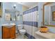 Charming bathroom with classic fixtures, including a vanity sink, toilet, and a shower with striped curtain at 4365 S Atlantic Ave # B8, New Smyrna Beach, FL 32169