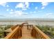 Wooden walkway providing easy access to the sandy beach and ocean at 4365 S Atlantic Ave # B8, New Smyrna Beach, FL 32169