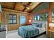 Bedroom with wood paneled walls, a ceiling fan, and bright, colorful accents at 4365 S Atlantic Ave # B8, New Smyrna Beach, FL 32169