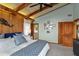 Comfortable bedroom with wood paneled walls, high ceilings, and a mermaid statue at 4365 S Atlantic Ave # B8, New Smyrna Beach, FL 32169