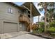 Exterior view of the home with a garage and stairs leading to the entrance at 4365 S Atlantic Ave # B8, New Smyrna Beach, FL 32169