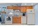 Well-lit kitchen features classic cabinetry and appliances, seamlessly blending with the dining area at 4365 S Atlantic Ave # B8, New Smyrna Beach, FL 32169