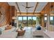 Cozy living room features wood paneled walls, ceiling beams, and beach views at 4365 S Atlantic Ave # B8, New Smyrna Beach, FL 32169