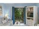 Cozy living room with comfortable seating and sliding doors to an outdoor deck surrounded by greenery at 4365 S Atlantic Ave # B8, New Smyrna Beach, FL 32169