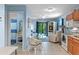 Cozy living space with views of the bathroom, living room, and kitchen, featuring light and airy decor at 4365 S Atlantic Ave # B8, New Smyrna Beach, FL 32169