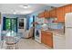 Open concept living space with a kitchen, dining area, and cozy living room with access to an outdoor deck at 4365 S Atlantic Ave # B8, New Smyrna Beach, FL 32169