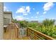 Deck with a partial view of the ocean, tropical greenery, and outdoor dining area at 4365 S Atlantic Ave # B8, New Smyrna Beach, FL 32169