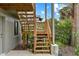 Wooden outdoor staircase with greenery around it, offering access to the upper level at 4365 S Atlantic Ave # B8, New Smyrna Beach, FL 32169