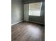Cozy bedroom with wood flooring and ample natural light from a large window at 4402 King Cole Blvd, Orlando, FL 32811
