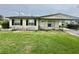 Modest single-story home featuring a covered front porch and a simple, grassy yard at 4402 King Cole Blvd, Orlando, FL 32811