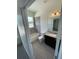 Neat bathroom with a shower-tub combo, granite-topped vanity, and tiled walls at 4624 Via Veneto Ct, Kissimmee, FL 34746