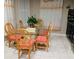 Bright dining room with tile floors, glass table and decorated with plant centerpiece at 4624 Via Veneto Ct, Kissimmee, FL 34746