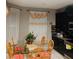 Dining area featuring a glass table, wooden chairs, decorative curtains, and stylish dark cabinetry at 4624 Via Veneto Ct, Kissimmee, FL 34746