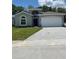 Charming single-story home with a well-maintained lawn and attached two-car garage at 4624 Via Veneto Ct, Kissimmee, FL 34746