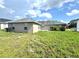 Backyard showing the rear exterior of the home under a sunny blue sky at 468 Rio Grande Ct, Kissimmee, FL 34759
