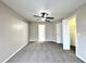 Bedroom features neutral colors, ceiling fan and lighting, carpeted floor, and closet space at 468 Rio Grande Ct, Kissimmee, FL 34759
