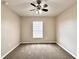 A bright bedroom features neutral carpet and walls, ceiling fan, and natural light from the window at 468 Rio Grande Ct, Kissimmee, FL 34759
