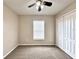 A bright bedroom features neutral carpet and walls, ceiling fan, a closet and natural light from the window at 468 Rio Grande Ct, Kissimmee, FL 34759