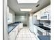 Bright kitchen showcases white cabinetry, stainless sink, tile flooring, and modern appliances at 468 Rio Grande Ct, Kissimmee, FL 34759