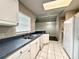 Kitchen showcasing countertops, stainless sink, white cabinets, tile flooring, and white refrigerator at 468 Rio Grande Ct, Kissimmee, FL 34759