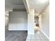 Open-concept living area with carpet flooring, gray walls and white trim, transitioning to tiled hallway at 468 Rio Grande Ct, Kissimmee, FL 34759