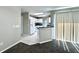 Open-concept living room with bright kitchen, and lots of natural light from the patio door at 468 Rio Grande Ct, Kissimmee, FL 34759