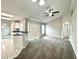 Open living space featuring carpeted flooring, kitchen view and large sliding glass doors at 468 Rio Grande Ct, Kissimmee, FL 34759