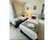 Cozy bedroom features two twin beds with accent pillows and neutral decor at 4700 Prairie Point Blvd, Kissimmee, FL 34746