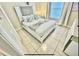 Modern bedroom with a sleek white platform bed, stylish bedding, and neutral color palette at 4700 Prairie Point Blvd, Kissimmee, FL 34746