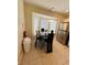 Inviting dining area with stylish seating, modern lighting, and stainless steel appliances at 4700 Prairie Point Blvd, Kissimmee, FL 34746