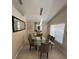 The dining room features a modern table, decorative mirror, and recessed lighting fixture at 4700 Prairie Point Blvd, Kissimmee, FL 34746