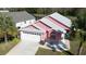 Aerial shot showcasing a two-story home with a well-manicured lawn and a two-car garage in a community at 4700 Prairie Point Blvd, Kissimmee, FL 34746