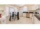 Bright kitchen featuring white cabinets, stainless steel appliances, and a glass-top dining table at 4700 Prairie Point Blvd, Kissimmee, FL 34746