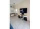 Cozy bonus room with a modern fireplace, mounted TV, and a foosball table at 4700 Prairie Point Blvd, Kissimmee, FL 34746