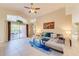 Spacious living room with high ceilings, large windows to patio, and comfortable sectional sofa at 4700 Prairie Point Blvd, Kissimmee, FL 34746