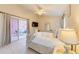 Inviting main bedroom featuring a sliding glass door to the lanai and neutral-colored walls at 4700 Prairie Point Blvd, Kissimmee, FL 34746