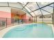Screened-in pool with covered lanai and steps into the water offering a delightful backyard retreat at 4700 Prairie Point Blvd, Kissimmee, FL 34746