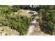 Aerial view of home, pool, and wooded land with long driveway at 4760 Ohio Ave, Sanford, FL 32771