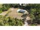 Expansive aerial view showcasing a secluded home with a pool and lush, mature landscaping at 4760 Ohio Ave, Sanford, FL 32771