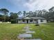 Charming single-story home with a welcoming front porch and stepping stone path leading to the entrance at 4760 Ohio Ave, Sanford, FL 32771