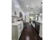 Updated kitchen with white cabinets, stainless steel appliances, and an open view to the dining and living areas at 4760 Ohio Ave, Sanford, FL 32771