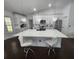 Modern kitchen featuring a spacious island with quartz countertops, white cabinets, and stainless steel appliances at 4760 Ohio Ave, Sanford, FL 32771