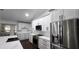 Modern kitchen featuring white cabinets, quartz countertops, and stainless steel appliances at 4760 Ohio Ave, Sanford, FL 32771