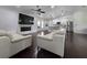 Open-concept living room with a modern fireplace, sleek furniture, and seamless flow to the updated kitchen at 4760 Ohio Ave, Sanford, FL 32771