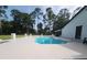 Inviting in-ground pool area with surrounding greenery, offering a private and serene outdoor retreat at 4760 Ohio Ave, Sanford, FL 32771