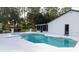 Sparkling pool and spa with white patio and screened in lanai at 4760 Ohio Ave, Sanford, FL 32771