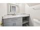 Bathroom vanity featuring gray cabinet, open shelf and marble countertop at 478 Chicago Woods Cir, Orlando, FL 32824