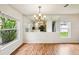 Bright dining room with hardwood floors, windows, and mirrored wall at 478 Chicago Woods Cir, Orlando, FL 32824