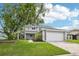 Charming two-story home with landscaped yard and attached two-car garage at 478 Chicago Woods Cir, Orlando, FL 32824