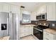 Kitchen featuring stainless appliances, tile backsplash and plenty of cabinet space at 478 Chicago Woods Cir, Orlando, FL 32824